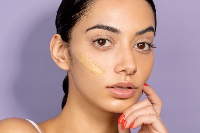 Model with foundation swatch on cheek